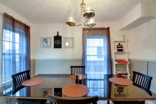 a dining room with two tables and chairs at Pet-Friendly Cottage in DWTN Brainerd in Brainerd