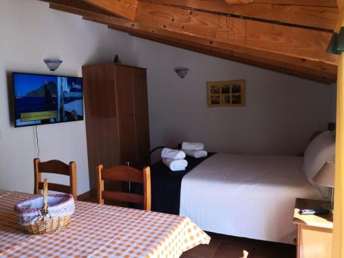 a bedroom with two beds and a table and a table and chairs at Sea Studio Apartment in Budens