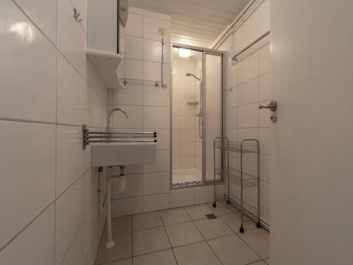 a bathroom with a sink and a shower at Holiday Home Sint Maartenszee near Beach in Sint Maartenszee