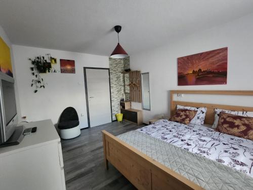 a bedroom with a large bed and a television at Rose 8 Bled in Bled
