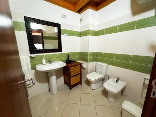 a bathroom with a sink and a toilet and a mirror at Soleil A9 in Santa Maria