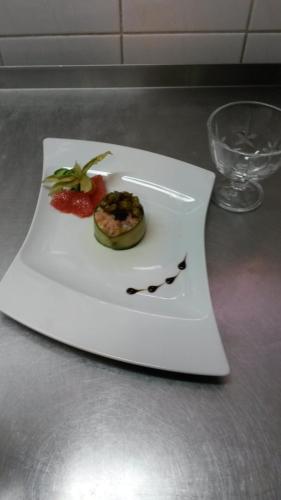 a white plate with a dessert on a table at Hotel Korona in Ciechanów