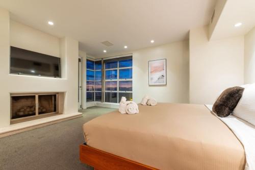 a bedroom with a large bed and a fireplace at Stunning Panoramic Ocean Views Penthouse Hot Tub in Manhattan Beach