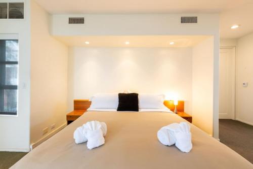 a bedroom with a bed with white towels on it at Stunning Panoramic Ocean Views Penthouse Hot Tub in Manhattan Beach
