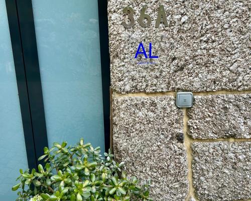 a stone wall with the letters al on it at Casa da Fonte, Monte in Terras de Bouro
