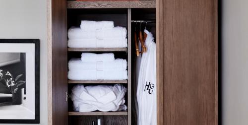 a wooden cabinet with towels in a room at HGU New York in New York