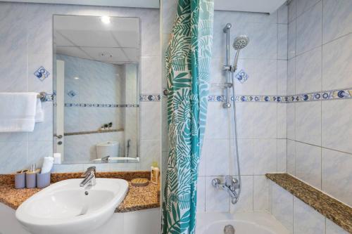 a bathroom with a sink and a shower at Elegant Haven and Spacious 2BR in Lake Terrace in Dubai