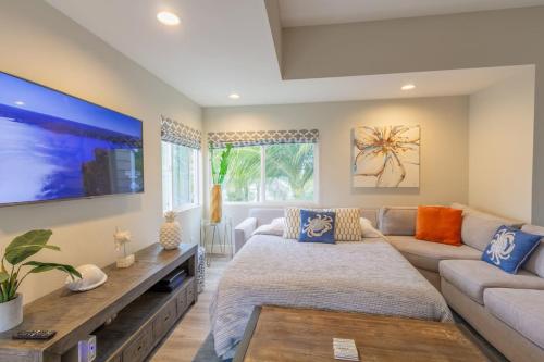 een woonkamer met een bed en een bank bij Chic Upstairs Condo Steps from Strands Beach in Dana Point