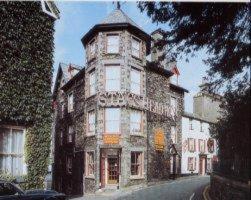 a large stone building on the side of a street at Stags Head Hotel in Bowness-on-Windermere
