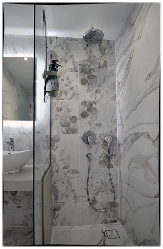 a bathroom with a shower and a sink at Theasis Sifnos Apartments in Platis Gialos