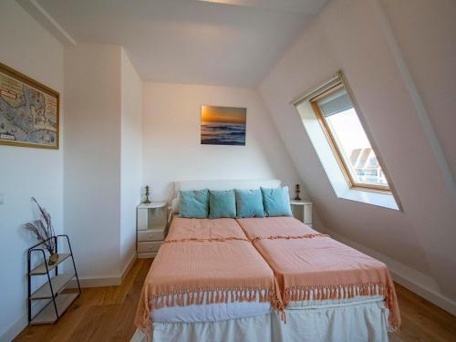 a bedroom with a large bed with blue pillows at Penthouse Duinerei by the sea with sauna in Callantsoog