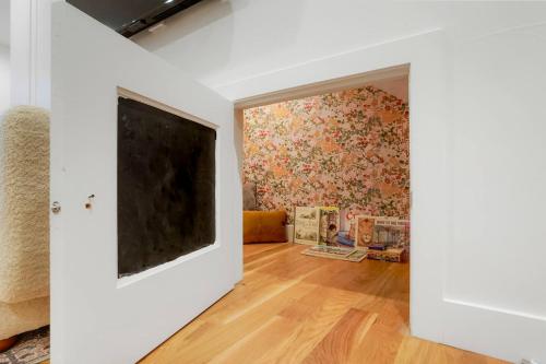 a living room with a wall with a floral wallpaper at Million Dollar Rooftop MTN Views -2 King Beds-DT Golden in Golden