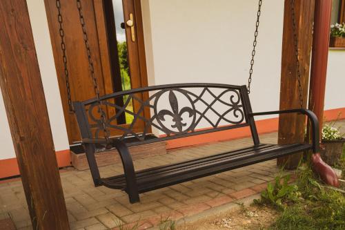 a swing sitting in front of a door at Domčeky Sabinka a Melinka in Valča