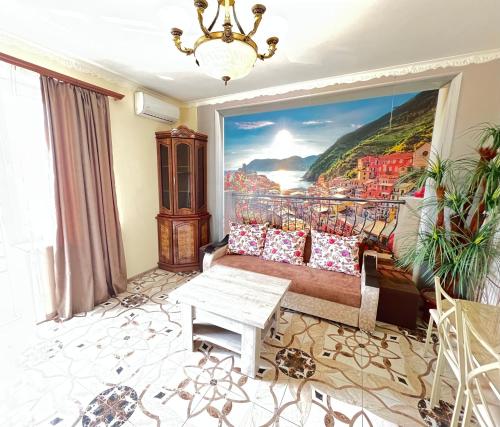 a living room with a couch and a large painting at Apartment in Yerevan Rubinyanc 27 21 Zeytun in Yerevan