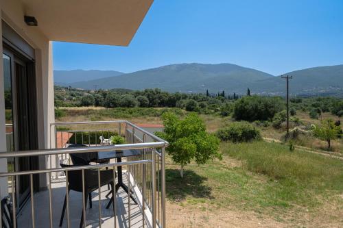 a balcony with a table and a view of the mountains at Maera Apartments in Sami