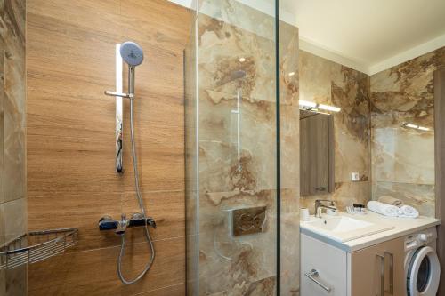 a bathroom with a shower and a sink at Maera Apartments in Sami