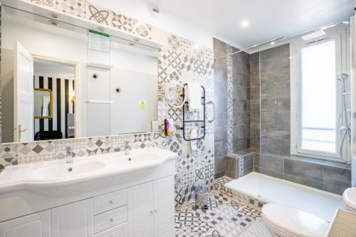 a bathroom with a sink and a toilet and a mirror at Sure Hotel by Best Western Port Jérome - Le Havre in Notre-Dame-de-Gravenchon