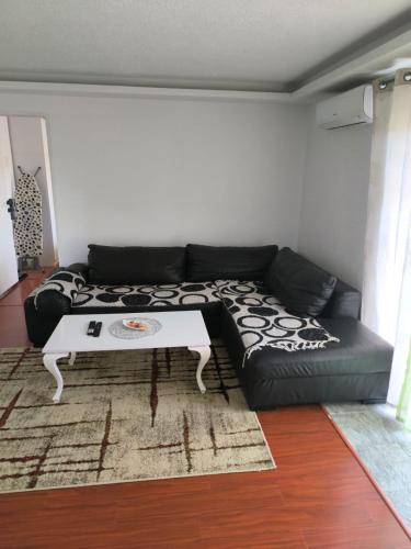 a living room with a couch and a table at Apartments Amina Sarajevo in Sarajevo
