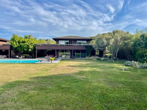 a house with a yard with a swimming pool at Apartments PETIT DOMAIN DE SPERONE in Bonifacio