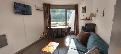 un salon avec un canapé et une table dans l'établissement Studio 4 personnes Vars les Claux 100m des pistes, à Vars