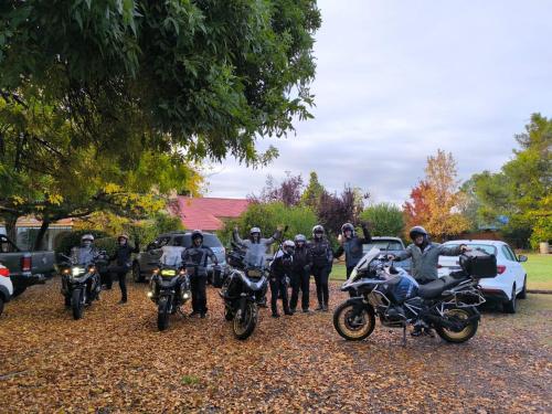 a group of people on motorcycles parked in a parking lot at La Masia in Chacras de Coria