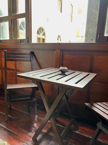 a wooden table and a chair next to a bench at Treasures of Zanzibar House in Zanzibar City