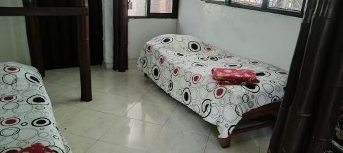 a white couch with a pattern on it in a room at El susurro del agua exclusiva - natural in Ibagué