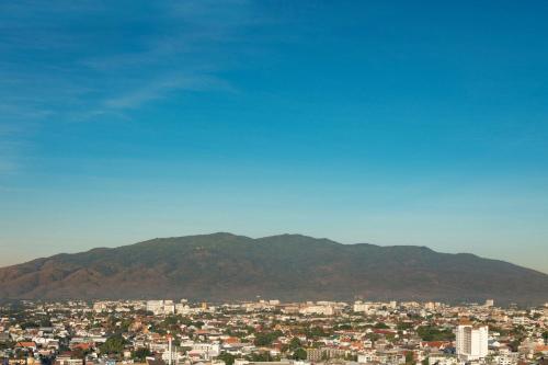 a city skyline with a mountain in the background at Chiang Mai Marriott Hotel in Chiang Mai