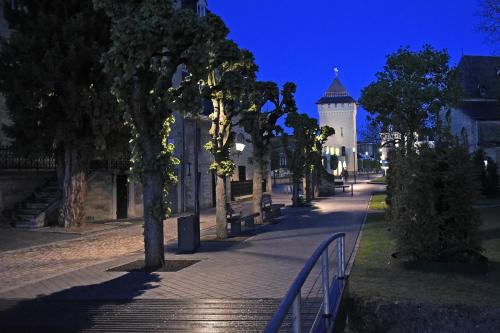 a street with a building with a gate and trees at Huis Ter Geul in Valkenburg