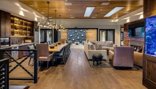 a living room filled with furniture and a dining room at Exclusive Villa with Expansive Space & Private Bar in Foxfield