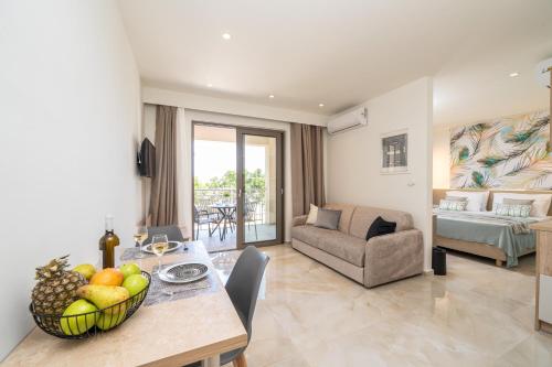 a living room with a table with a bowl of fruit at Maera Apartments in Sami