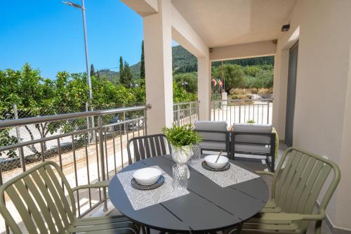 a dining table and chairs on a balcony with a view at Maera Apartments in Sami