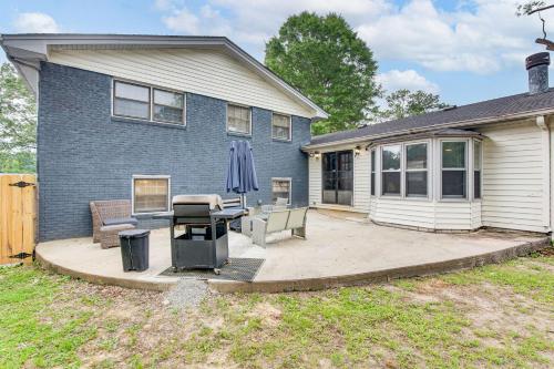 a house with a patio with a table and an umbrella at 6 Mi to Airport Riverdale Home with Private Pool! in Riverdale