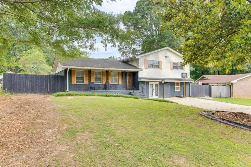 a house with a fence in front of a yard at 6 Mi to Airport Riverdale Home with Private Pool! in Riverdale