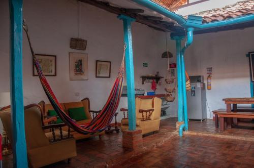 a room with chairs and a hammock in a room at Casa Laurel and Tomillo Casa Barichara 2 in Barichara