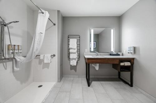 a bathroom with a sink and a mirror at La Quinta Inn & Suites by Wyndham La Habra in La Habra