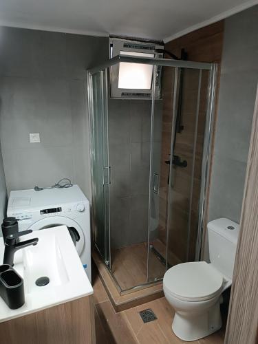 a bathroom with a shower and a toilet and a sink at Heraklion Central Studio MaZa1 in Néa Alikarnassós