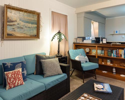 a living room with a blue couch and a chair at Silver Heart Inn & Cottages in Independence