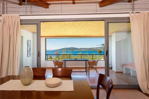 a living room with a table and a view of the ocean at Sea & Salt ,Pelion,Agria Volos in Agria
