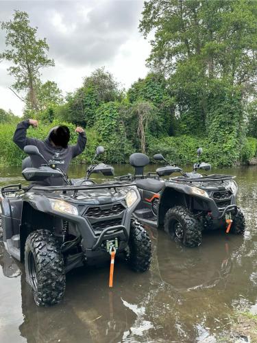 a person on a four wheeler in a river at Siedlisko Rawka in Doleck