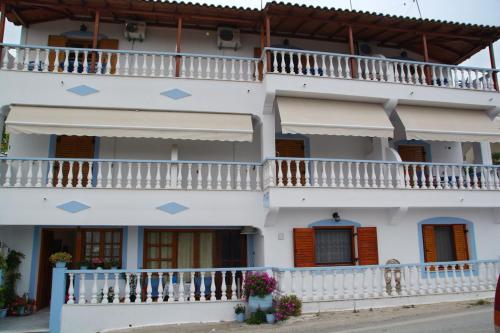 a large white building with balconies on it at Myriam Studios in Patitiri
