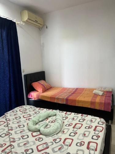 a room with two beds and a blanket on the floor at Apartments Murati in Ulcinj