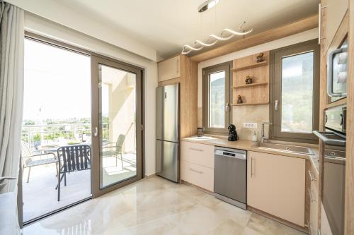 a kitchen with a view of a balcony at Maera Apartments in Sami