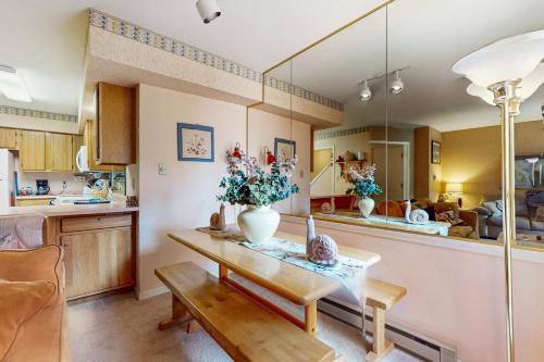 a living room with a table with a vase on it at Gold Dust F3 in Angel Fire