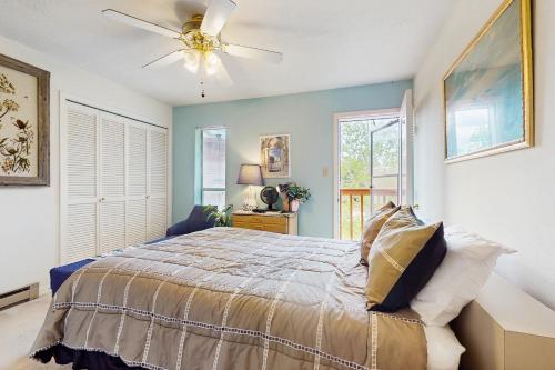 a bedroom with a bed and a ceiling fan at Gold Dust F3 in Angel Fire