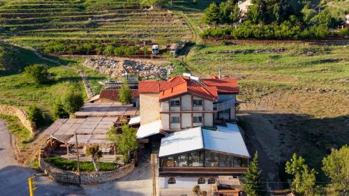 an aerial view of a house with a roof at Urban Faqra Hotel in Kfardebian