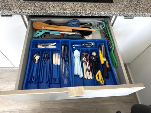 a drawer full ofrenches and other tools under a counter at Villa's Pomar do Moinho - 5 minutes from Óbidos in Usseira