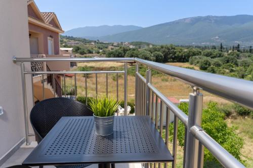 a patio table with a plant on a balcony at Maera Apartments in Sami