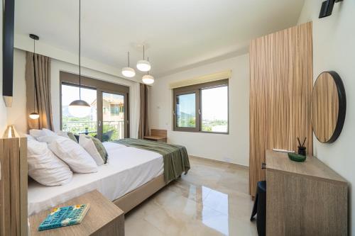 a bedroom with a bed and a large window at Maera Apartments in Sami