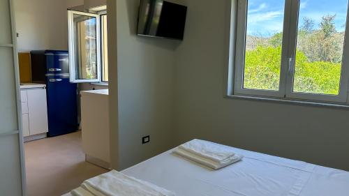 Postel nebo postele na pokoji v ubytování VentunoDodici Oliveri Apartments